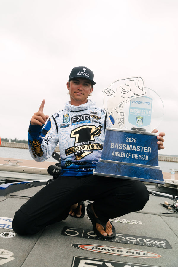 Trey McKinney holding the 2026 Progressive Bassmaster Angler of the Year trophy, powered by ABYSS BATTERY® lithium marine batteries